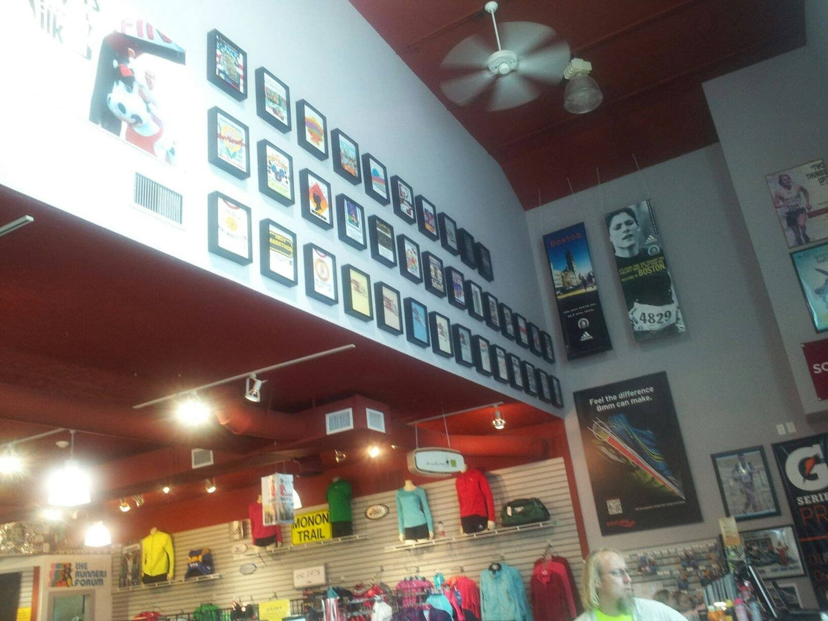 Large Retail Shart T-Shirt Frame Display with Running, Jogging and Race T-Shirts framed and displayed at a Running Store